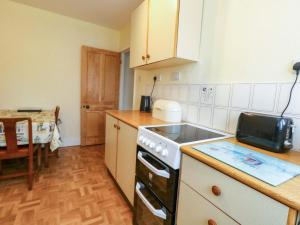 a kitchen with a sink and a stove at Bay View in Swanage