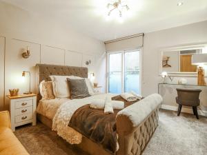 a bedroom with a large bed and a window at Hafod Y Bryn in Harlech