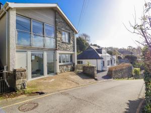 a brick house with glass doors on a street at Hafod Y Bryn in Harlech
