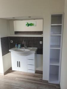 a bathroom with a sink and a mirror at Kranichhof in Hohwacht +30 photos