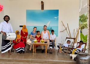 a family posing for a picture in a living room at Crystal sea inn in Bileffahi