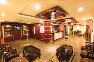 a large room with chairs and a barber shop at Hotel Indraprastha, Pattazhy in Avanīsvaram +10 photos