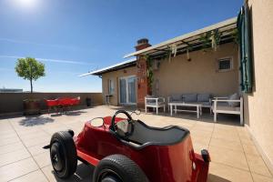 a small red car parked on a patio at Siera's Penthouse in Prishtinë