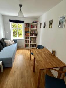 a living room with a table and a couch at Cosy rooms & garden in Asker