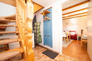 a room with a staircase and a blue door at Alte Scheune Koserow bei Baltic Home in Koserow