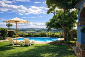 a pool with a table and chairs and an umbrella at La Masseria in Vasto +31 photos
