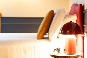 a bottle of wine and a corn on a bed at JOIVY Together Florence Secret Nest in Florence