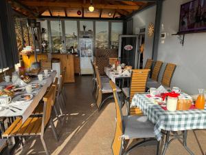 a restaurant with tables and chairs with food on them at Dreams Hotel in Gjirokastër