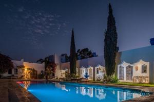 a villa with a swimming pool at night at ecrin mogador in Aït Sidi Saïd +88 photos