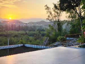 a view of the sunset from a house at Phunapat camping Dome in Ban Song Phi Nong