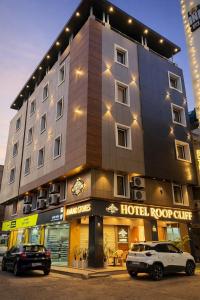a hotel building with cars parked in front of it at Hotel Roop Cliff, Bhopal in Bhopal