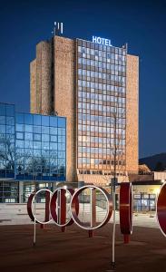 a hotel building with a sign in front of it at Interhotel Tatra in Kopřivnice