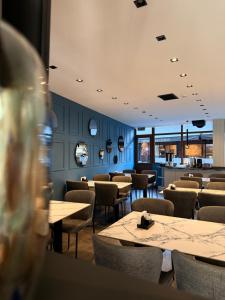 a dining room with tables and chairs and blue walls at Otel 57 in Sinop