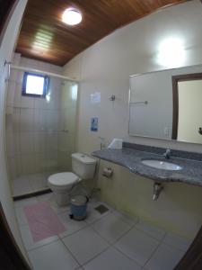 a bathroom with a toilet and a sink and a mirror at Pousada Cavalo Marinho Anexo in Abraão