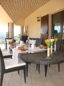 a dining room with a table and chairs with flowers at Relais Il Monticello in Montefiore Conca