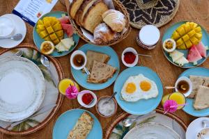 a table topped with blue plates of breakfast foods at TWIGA APARTHOTEL by Sofia Collection in Pwani Mchangani
