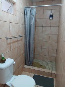 a bathroom with a shower with a toilet at Martinique Guesthouse in Kathu +18 photos