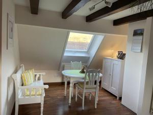 a dining room with a table and chairs and a window at Haus am Kastanienwald in Bad Bergzabern