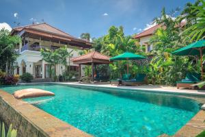 a swimming pool in front of a house at Villa Mata Hari in Panji