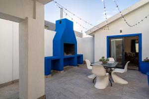 a room with a table and chairs and a fireplace at The Lighthouse in Cape Town