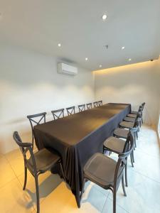 a conference room with a long table and chairs at LeBlanc Hotel in Antipolo