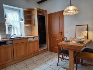 a kitchen with a wooden table and a dining room at Ferienhaus in Clenzer Schweiz in Clenze