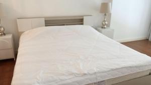 a white bed in a bedroom with two night stands at 1 BR Loft Condo in Cha-Am in Cha Am
