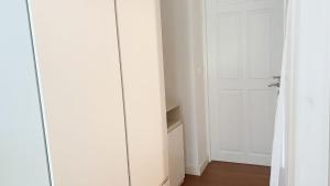 a room with white cabinets and a white door at 1 BR Loft Condo in Cha-Am in Cha Am +2 photos