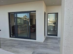 a room with sliding glass doors in a house at SeeSkattie in St. Helena Bay