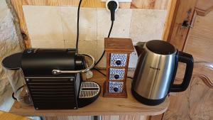 a toaster and a coffee maker on a table at LA GARDE ADHEMAR, L'escalier Médiéval in La Garde-Adhémar