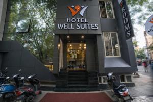 a hotel lobby with motorcycles parked outside of it at Hotel Well Suites Koramangala in Bangalore
