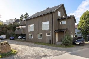 a wooden house with a car parked in front of it at Apartment close to the mountain in Svolvær
