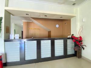 a lobby with a reception desk in a building at Wisma Mutiara Syariah Langsa in Langsa
