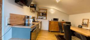 a kitchen with a counter top and a wooden table at FeWo-Hacke in Halblech