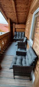 a room with couches and chairs in a cabin at FeWo-Hacke in Halblech
