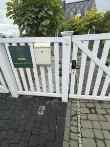 a white fence with a sign on it at Apartament Premium Pola in Bolesławiec