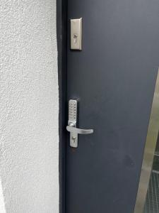 a blue door with a remote control on it at Apartament Premium Pola in Bolesławiec +22 photos