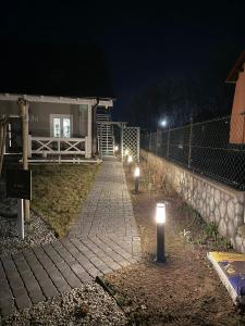 a brick walkway with lights in front of a house at Apartament Premium Pola in Bolesławiec