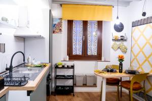 a small kitchen with a sink and a table at Casa Rachele alloggio turistico in Sabina in Poggio Mirteto