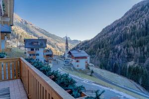 a view from a balcony of a town with a mountain at Appartamento Lucia in Penia