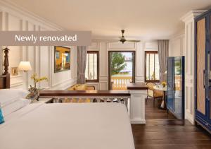 a bedroom with a bed and a living room at Anantara Hoi An Resort in Hoi An