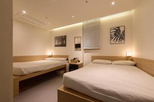 a bedroom with two beds and a window in it at Artravel Myeongdong in Seoul