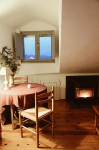 a table and chair in a room with a fireplace at La ventanuca del Valle in Bielva +23 photos