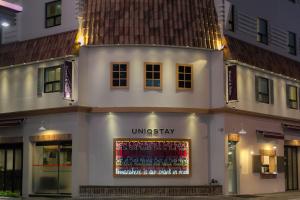 a white building with a display in the window at Uniqstay in Busan