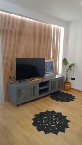 a living room with a flat screen tv on a table at Thermi Luxury apartments in Thermi