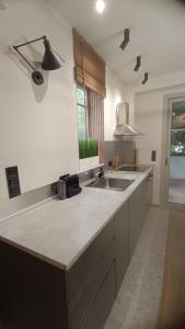 a kitchen with a sink and a counter top at Thermi Luxury apartments in Thermi