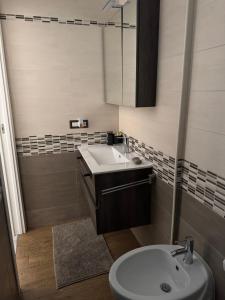 a bathroom with a sink and a toilet at Eleven Home in Bari