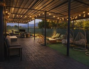 a pavilion with lights and furniture on a patio at Sun Garden Glamping Domes in Călimăneşti