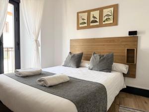 a bedroom with a large bed with two pillows on it at Balhondo Open Village in Puebla de Alcocer