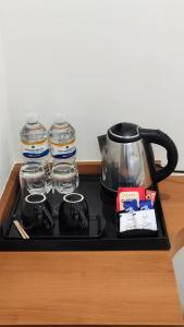 a tea kettle and jars of water on a counter at Darling Grand SME in Vellore